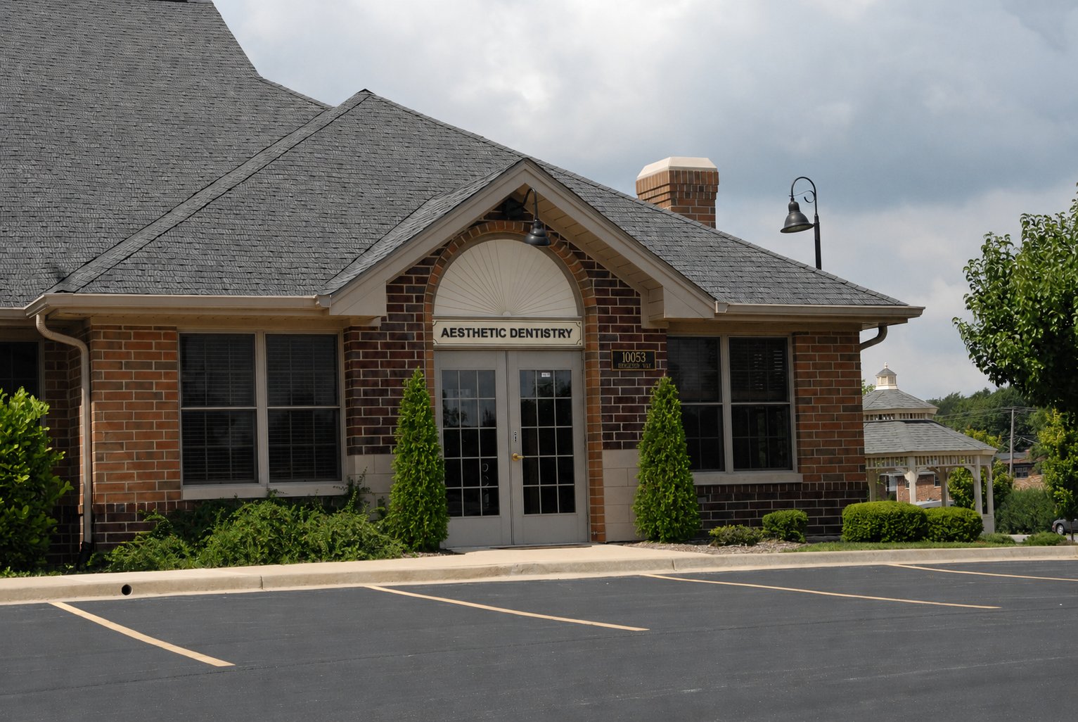 Front exterior of Aesthetic Dentistry of Frankfort with brand signage above the entrance