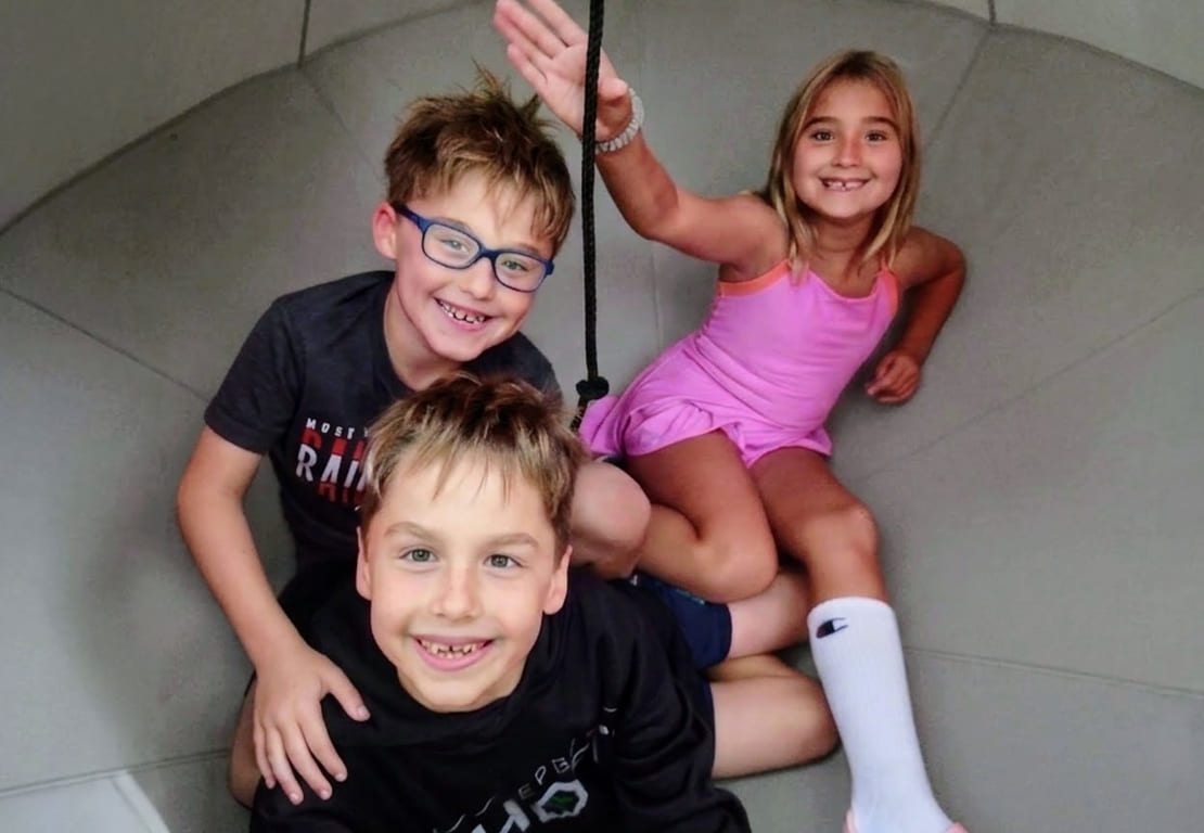 Three grinning children, illustrating children's dentistry at Aesthetic Dentistry